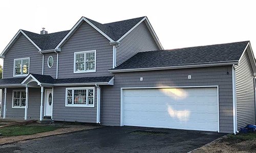 Front view of a home with new blue siding installed by Allsite Roofing LLC
