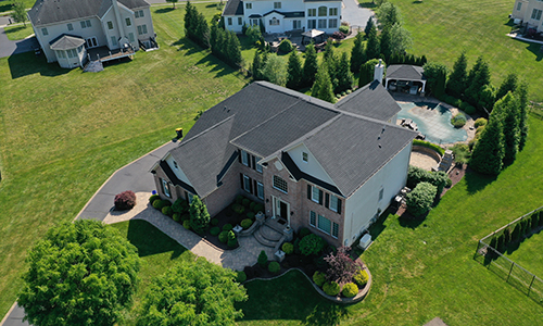 Close up of a residential roof with brand new light brown Owens Corning shingles installed by Allsite Roofing LLC